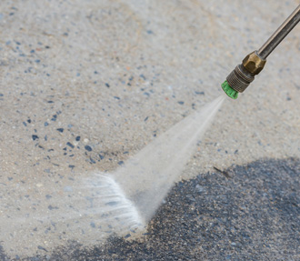 Flat nozzle pressure washing on concrete surface during cleaning